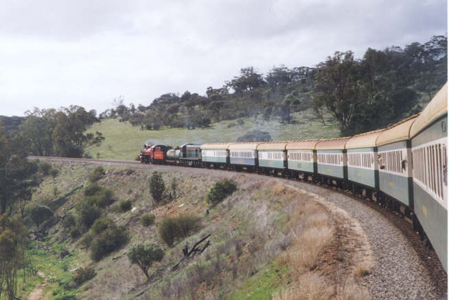 Pm 706 and C1703 hurry the train up through the Avon Valley. Behind the locomotives can be seen the Galley Car and the Blue Ribbon Diner. It is thought that this is the first time the Diner has been hauled by steam.                             Photo by N Blinco 